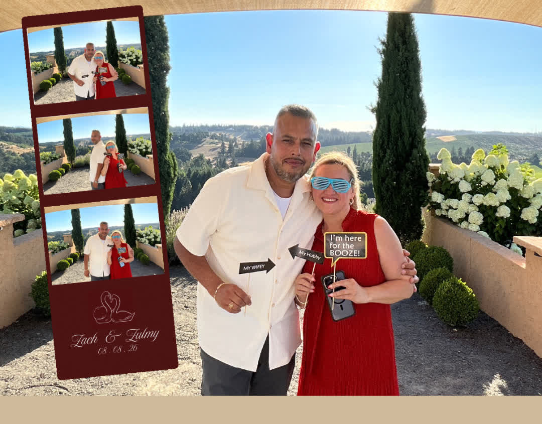 Couple with props and their photo strip at a wedding photo booth