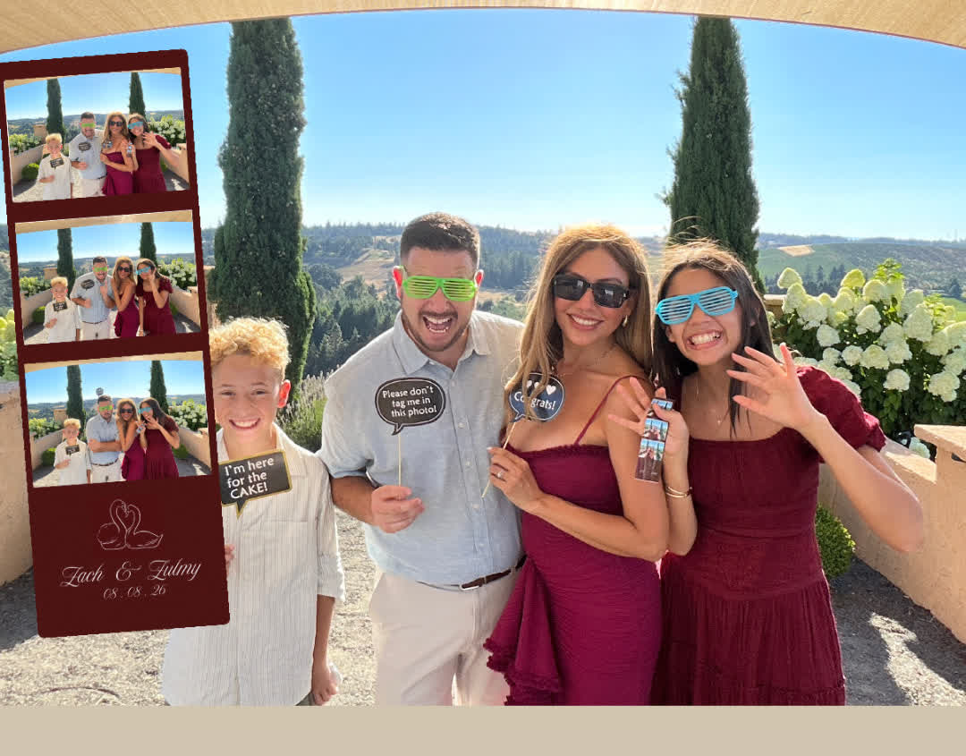 Family of four with props holding their photo booth strip